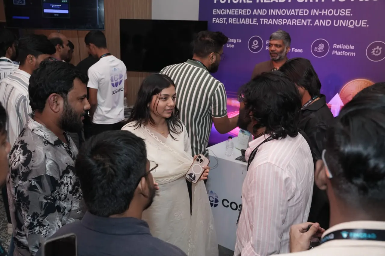 Attendees watching a product walkthrough on the booth screens