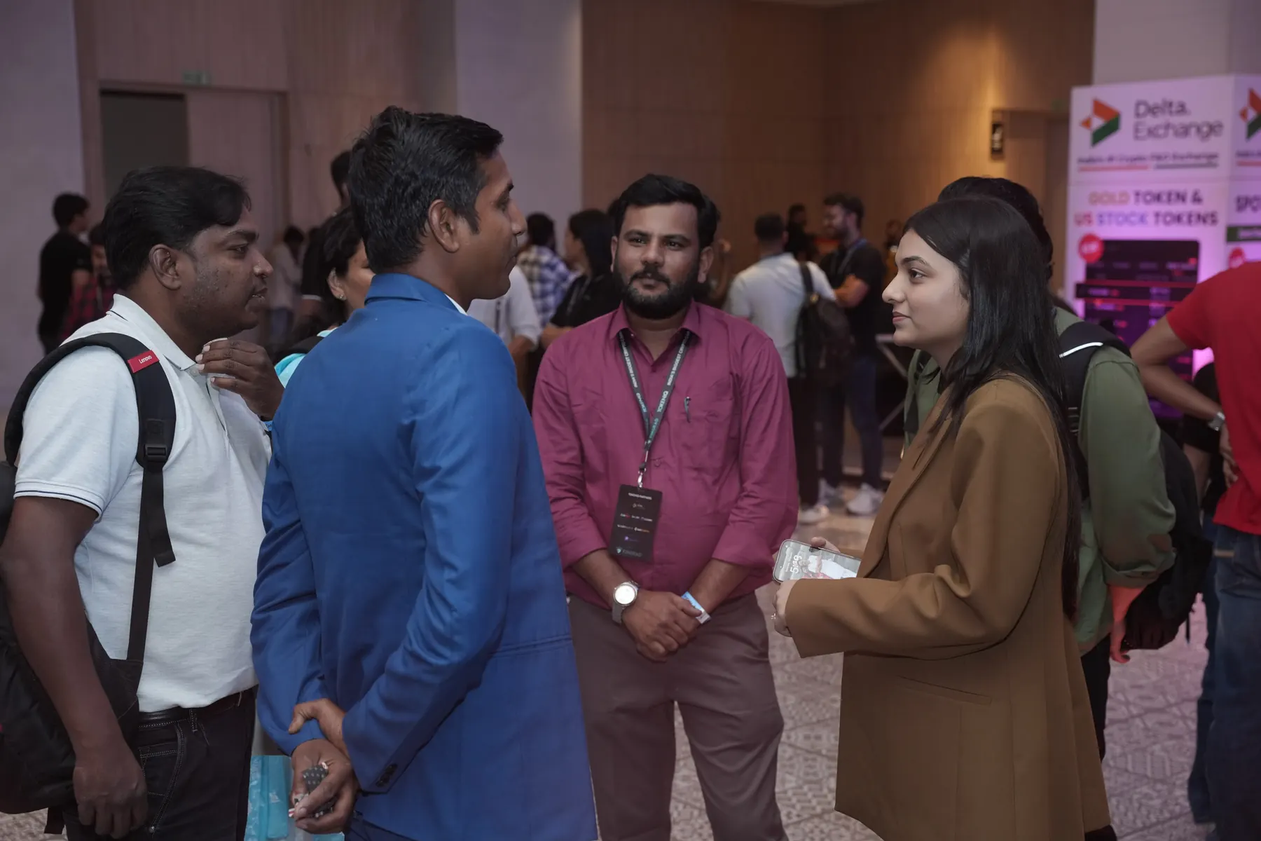 Attendees networking in the foyer between sessions