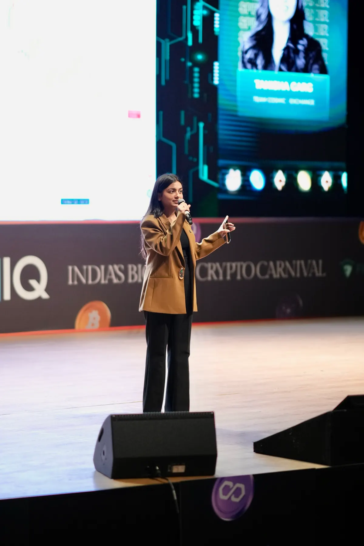 A speaker mid-session on a conference stage