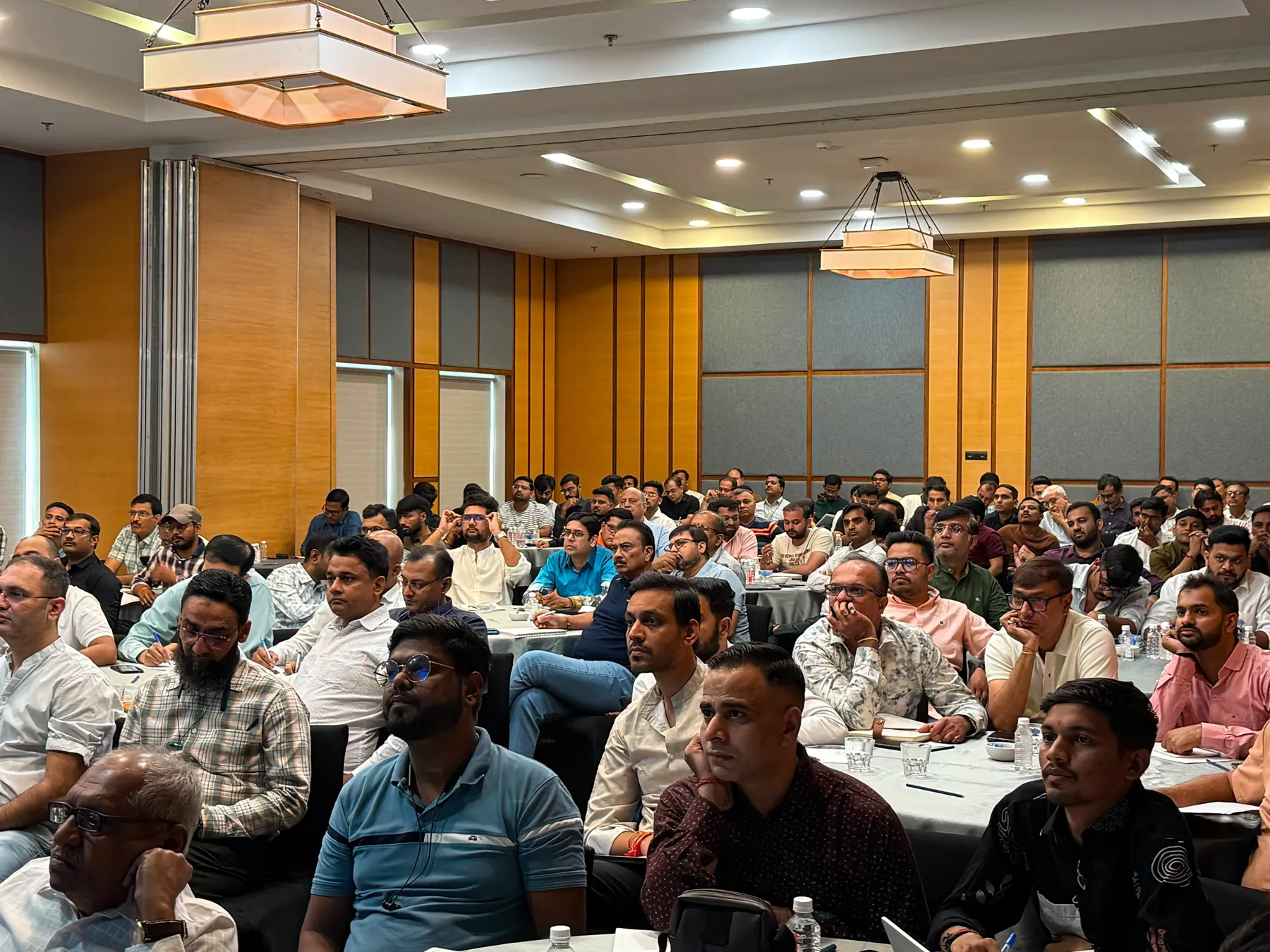 Attendees following along at a workshop in a banquet hall