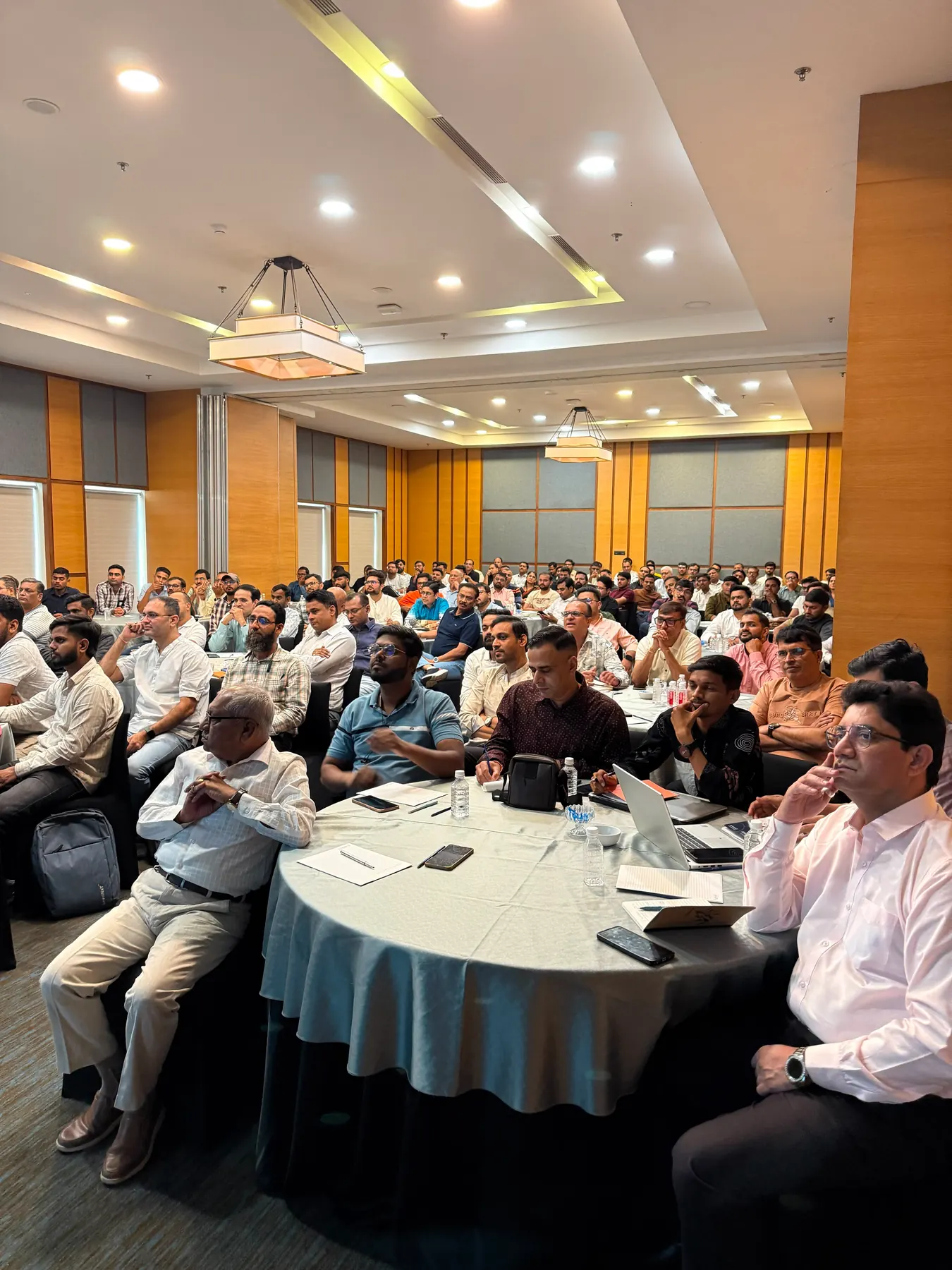 A wide view of a packed workshop room