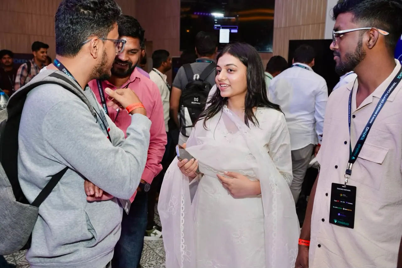 Attendees in conversation on the exhibition floor
